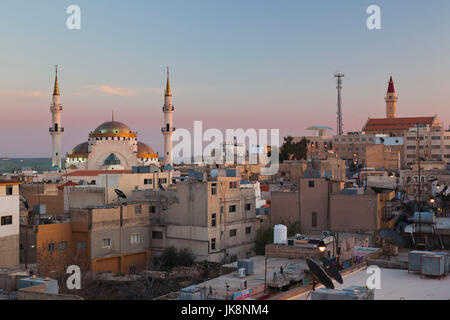 Jordan, Kings Highway, Madaba, elevated town view with mosque, dusk Stock Photo