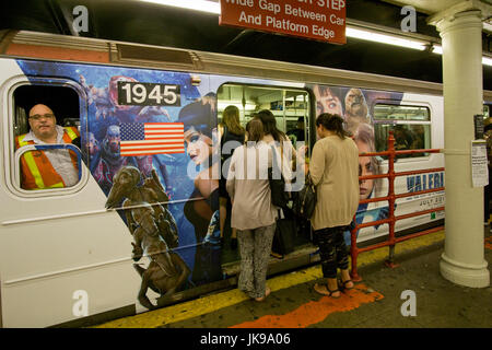 A crowd of passengers board the Times Square to Grand Central Station shuttle midday in MIdtown Manhattan, New York City. Stock Photo