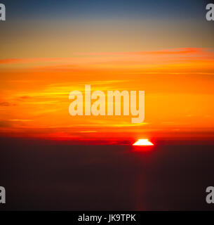 Sunset at 30.000ft taken from passenger aircraft Stock Photo