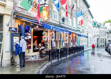 Quebec City, Canada - May 31, 2017: Old town street Rue Couillard with man reading menu of Portofino restaurant Stock Photo