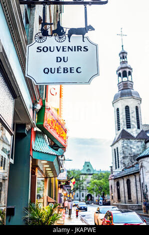 Quebec City, Canada - May 31, 2017: Old town street with Souvenirs sign at Boutique Champlain Cadeaux and Notre Dame Cathedral in the evening Stock Photo