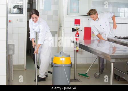 kitchen aids are cleaning the restaurant kitchen Stock Photo