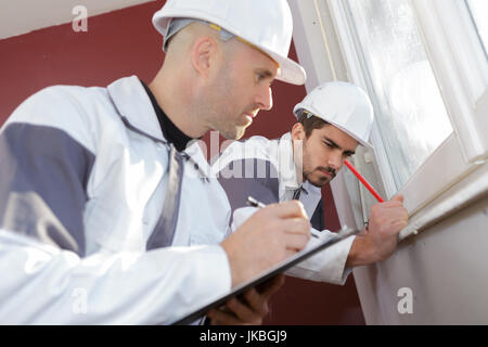 man installing cassette roller blinds on windows Stock Photo