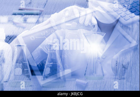 Scientist working in laboratory, testing samples with chemical bond on a blackboard background and blue fliter, light flare,  science technology Stock Photo
