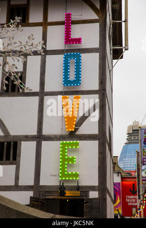 The Globe Theatre in London with the word LOVE in coloured neon lights Stock Photo