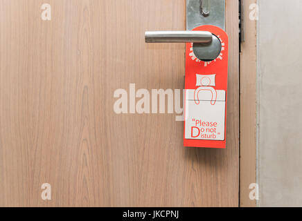 Do not disturb sign on door knob in hotel Stock Photo