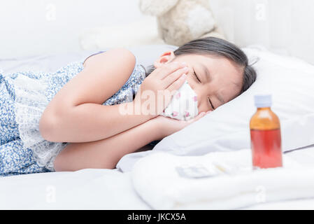 sick girl lying in bed and sore throat and cough, healthcare concept Stock Photo