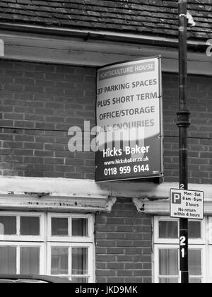 Hicks Baker estate agent board above vacant property, office and storage space Stock Photo