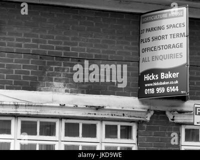 Hicks Baker estate agent board above vacant property, office and storage space Stock Photo