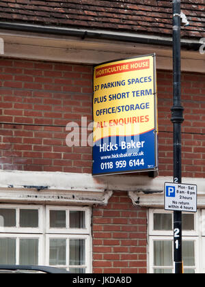 Hicks Baker estate agent board above vacant property, office and storage space Stock Photo