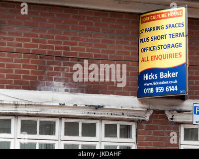 Hicks Baker estate agent board above vacant property, office and storage space Stock Photo