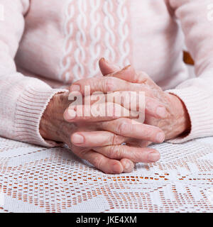 Old hands. Holding hands, horizontally view from front. Stock Photo