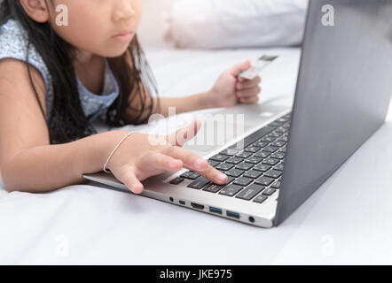 Online shopping.Hands holding credit card and push on enter button laptop. selective focus Stock Photo