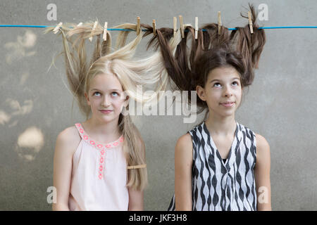 Girls hair drying on clothesline Stock Photo