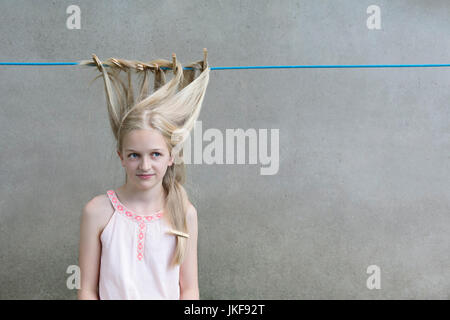 Blond girl's hair drying on clothesline Stock Photo