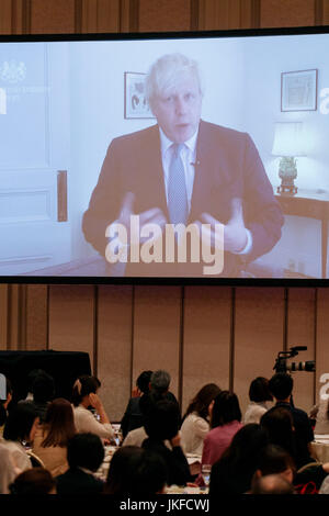 People look at the the video message from Britain's Foreign Secretary Boris Johnson during the 22nd International Conference for Women in Business at Grand Nikko Tokyo Daiba on July 23, 2017, Tokyo, Japan. 55 guest speakers, principally female leaders, gathered to discuss the roles of women in politics, business and society. The annual conference has been held since 1996. Credit: Rodrigo Reyes Marin/AFLO/Alamy Live News Stock Photo