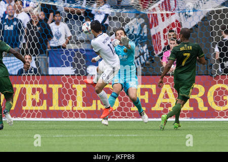 Vancouver, Canada. 23 July 2017. Fredy Montero (12) of Vancouver Whitecaps attepting to score is robbed by goalkeeper Jake Gleeson (90) of Portland Timbers.  Vancouver Whitecaps vs Portland Timbers BC Place Stadium. Portland wins 2-1 over Vancouver.  Credit: Gerry Rousseau/Alamy Live News Stock Photo