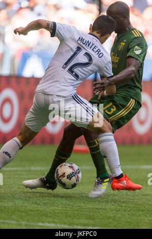 Vancouver, Canada. 23 July 2017. Fredy Montero (12) of Vancouver Whitecaps, and Lawrence Olum (13) of Portland Timbers, fighting for the ball.  Vancouver Whitecaps vs Portland Timbers BC Place Stadium. Portland wins 2-1 over Vancouver.  Credit: Gerry Rousseau/Alamy Live News Stock Photo