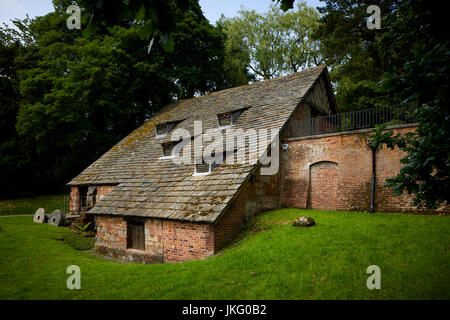 Exterior buff-pink ashlar sandstone Nether Alderley Mill 16th-century watermill  Nether Alderley, Cheshire, England. designated Grade II* listed build Stock Photo