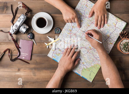 Young couple planning  vacation trip with map. Top view. Pointing to Thailand map Stock Photo