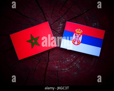 Moroccan flag with Serbian flag on a tree stump isolated Stock Photo