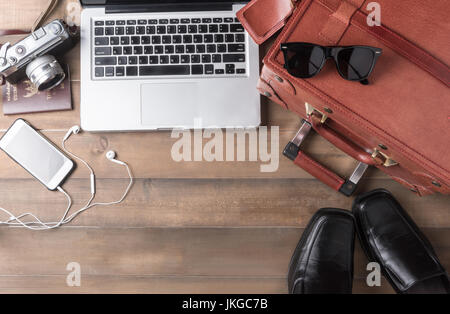 prepare accessories and travel items for business man on brown wooden board, flat lay, top view background Stock Photo