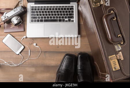 prepare accessories and travel items for business man on brown wooden board, flat lay, top view background Stock Photo