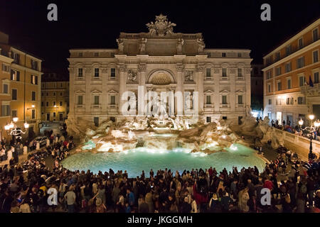 Horizontal view of the Trevi Fountain lit up at night in Rome.