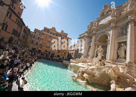 Horizontal view of tourists gathered around the Trevi Fountain in Rome. Stock Photo