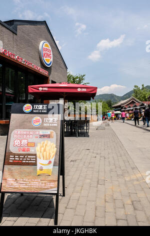 A Burger King fast food restaurant at the base of the Great Wall of China at Mu Tian Yu Stock Photo