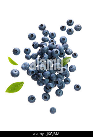 Fresh Blueberries With Leaves on White Background. Scattered blueberries over white background. Stock Photo