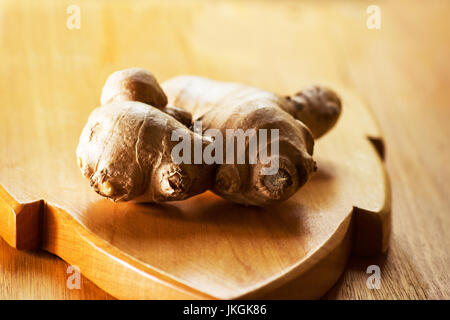 Ginger root on wooden board Stock Photo