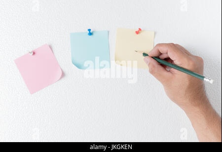 hand man write on paper note with pin on foam sheet, concept remember and memory Stock Photo