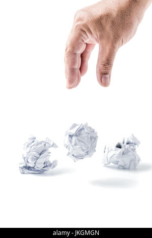 Hand taking a crumpled paper ball isolated on white background Stock Photo