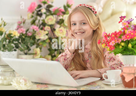 Cute teen girl using laptop Stock Photo - Alamy