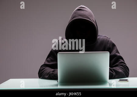 Hackers programmer using computer laptop for hack information and data from user account Stock Photo