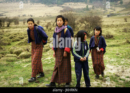 Girls walking home from school in Phobijikha valley, Bhutan Stock Photo