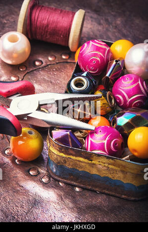 Retro box with different beads and decorations for needlework Stock Photo
