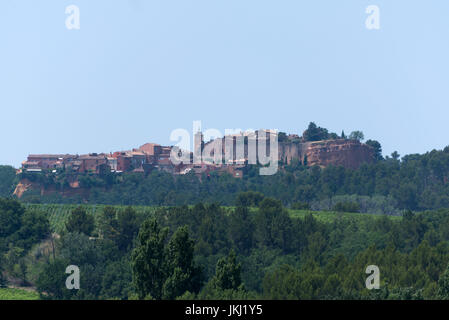 view over winegrowing fields to hilltop village Roussillon, Provence, France Stock Photo