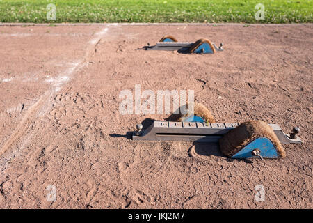 starting blocks on cinder track Stock Photo