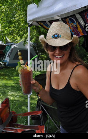 Woman drinking a bloody mary Stock Photo