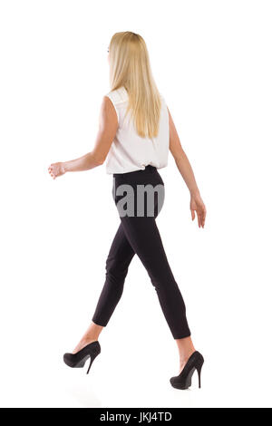 Blond woman in black leggings, high heels and pink sweater is walking and  smiling. Side view. Full length studio shot isolated on white Stock Photo -  Alamy