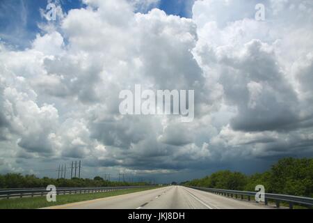 Vast Vista of Dark, Ominous, Dramatic, Approaching Rain Clouds Above a Highway, Traveling North on the Florida Turnpike toward Orlando Stock Photo