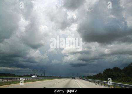 Vast Vista of Dark, Ominous, Dramatic, Approaching Rain Clouds Above a Highway, Traveling North on the Florida Turnpike toward Orlando Stock Photo