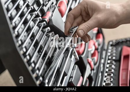 Open toolbox and male hand Stock Photo
