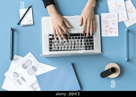 Woman using laptop in office Stock Photo