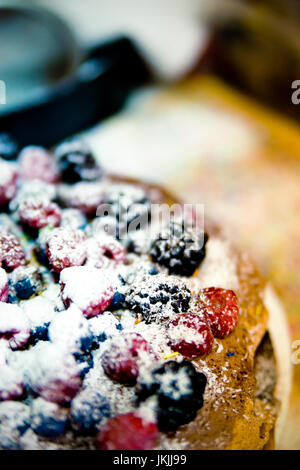 Fresh homemade forest fruits cake with wild fresh blueberries and raspberries. Cake with berries. Stock Photo