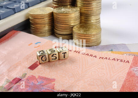 GST wording and gold coins. Stock Photo