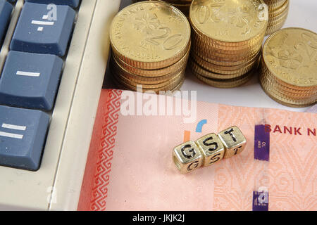 GST wording and gold coins. Stock Photo