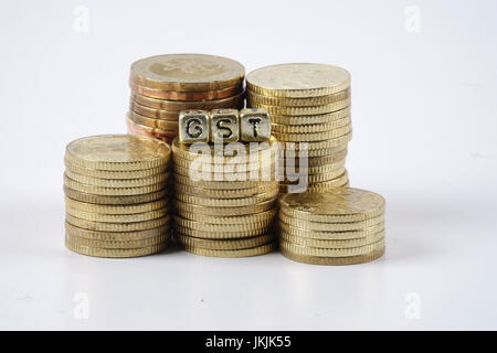 GST wording and gold coins. Stock Photo